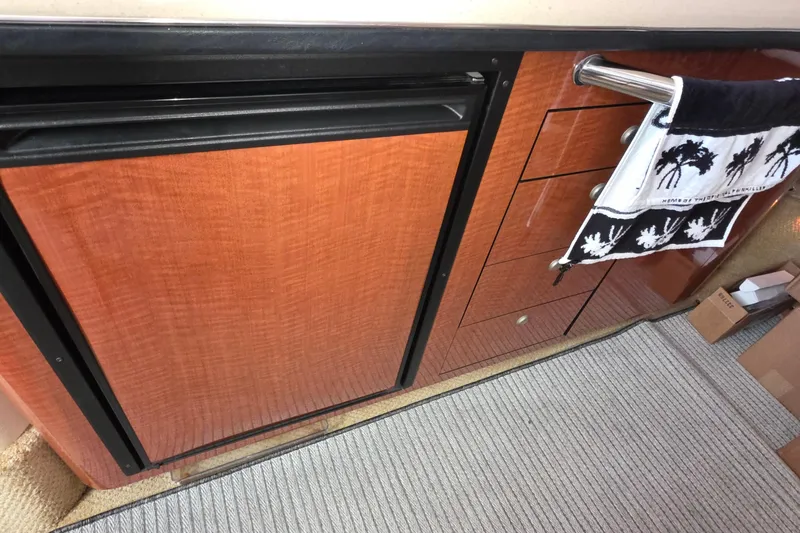 Slide: The Image of 2005 Sea Ray 340 Sundancer interior with wood cabinetry and towel rack. - 29