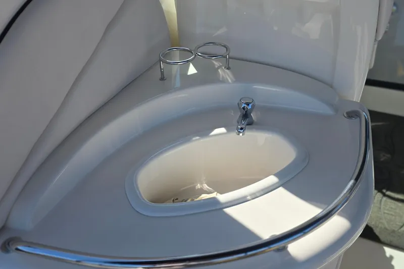Slide: The Image of 2005 Sea Ray 340 Sundancer boat sink with chrome faucet and cup holders. - 6
