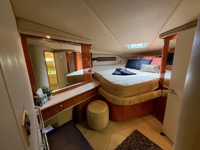 Slide: The Image of Luxurious cabin of 1998 Sea Ray 500 Sundancer with bed and mirror. - 36