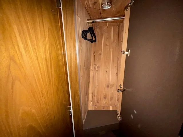 Slide: The Image of Interior of a 1998 Sea Ray 500 Sundancer closet with wood finish. - 37