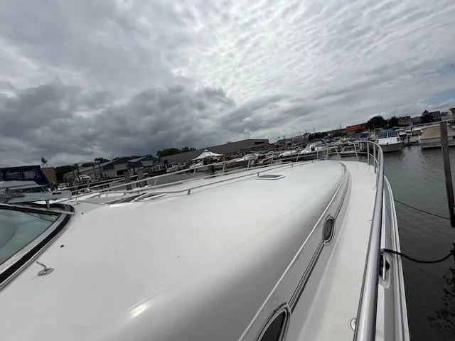 Slide: The Image of 1998 Sea Ray 500 Sundancer docked under cloudy skies. - 4