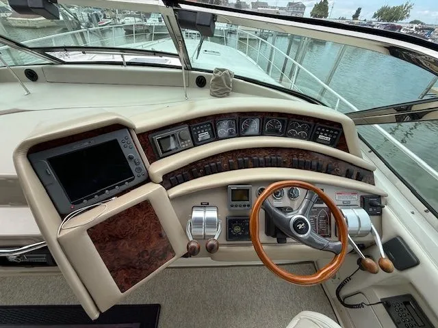 Slide: The Image of 1998 Sea Ray 500 Sundancer cockpit with steering wheel and instruments. - 9