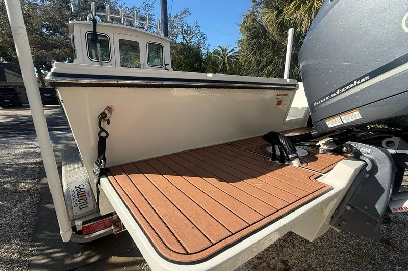 Slide: The Image of 2020 Parker 2320 SL Sport Cabin with Yamaha outboard motor, docked outdoors. - 10