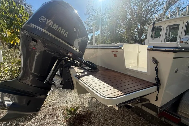 Slide: The Image of 2020 Parker 2320 SL Sport Cabin boat with chrome logo on white hull. - 11