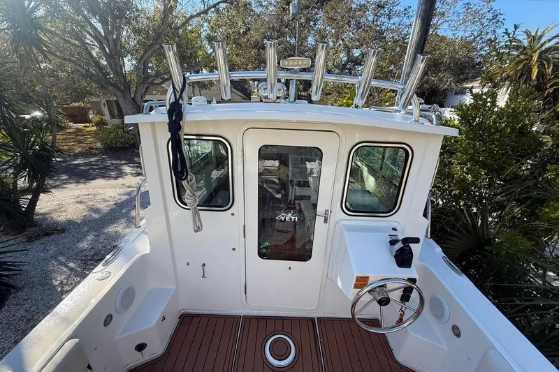 Slide: The Image of 2020 Parker 2320 SL Sport Cabin boat deck with rod holders and railing. - 22