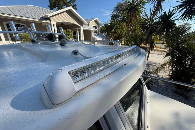 Slide: The Image of 2020 Parker 2320 SL Sport Cabin boat with open cabin door and steering wheel. - 28