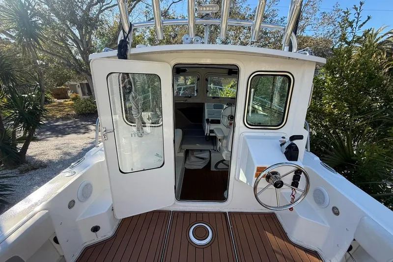 Slide: The Image of Interior of 2020 Parker 2320 SL Sport Cabin with helm and seating. - 29