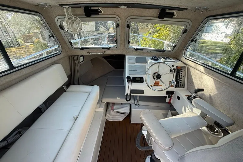 Slide: The Image of 2020 Parker 2320 SL Sport Cabin interior with cushioned seating and Garmin equipment. - 30