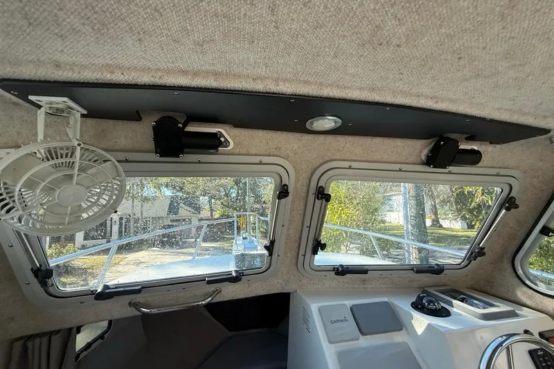 Slide: The Image of 2020 Parker 2320 SL Sport Cabin helm with Garmin navigation and communication equipment. - 33