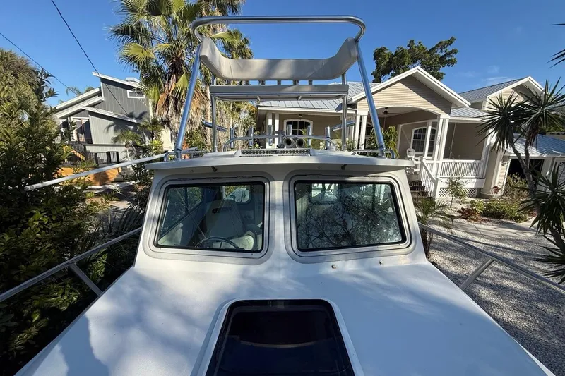 Slide: The Image of 2020 Parker 2320 SL Sport Cabin boat with stainless steel railings, docked near a house. - 42