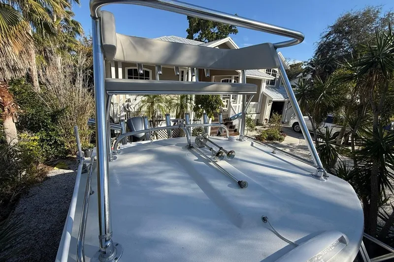 Slide: The Image of 2020 Parker 2320 SL Sport Cabin boat with elevated seating, parked near a house. - 43