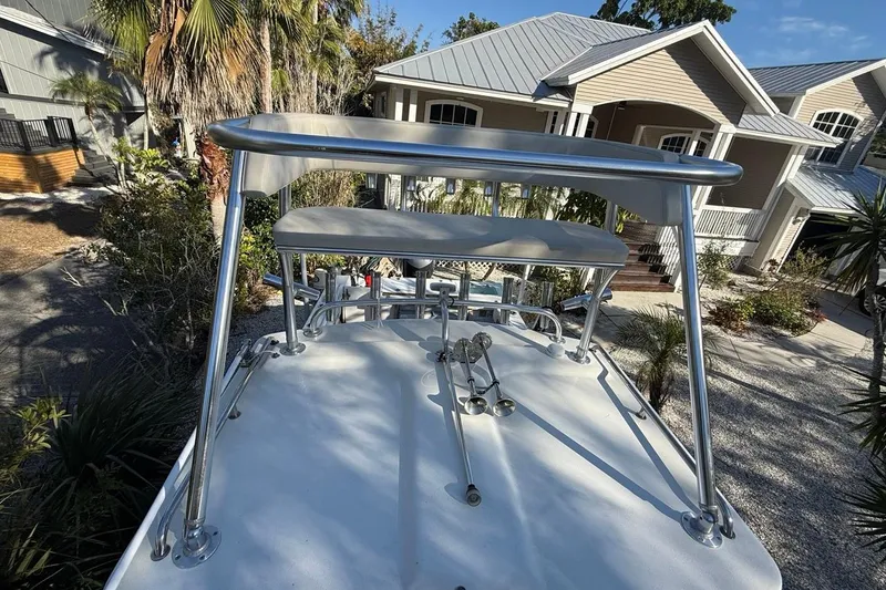 Slide: The Image of 2020 Parker 2320 SL Sport Cabin boat with rod holders and tower against blue sky. - 44