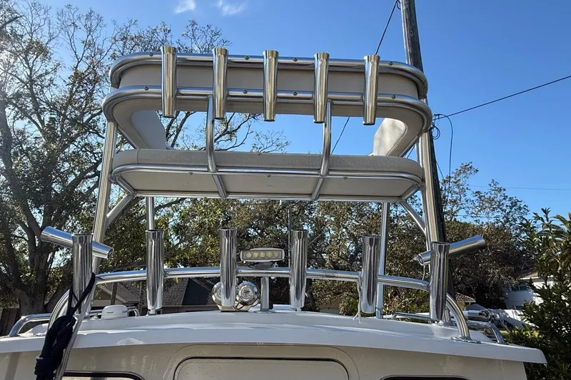 Slide: The Image of 2020 Parker 2320 SL Sport Cabin boat with helm, surrounded by trees. - 45