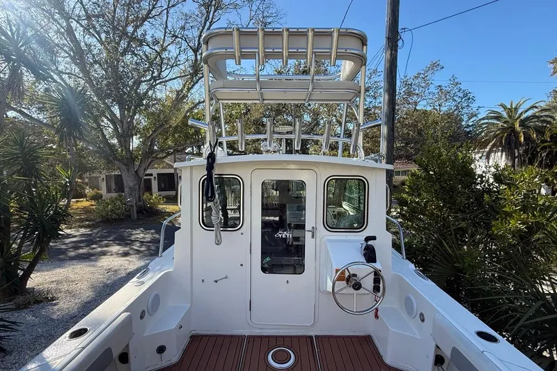 Slide: The Image of 2020 Parker 2320 SL Sport Cabin boat on trailer with Yamaha outboard motor. - 46