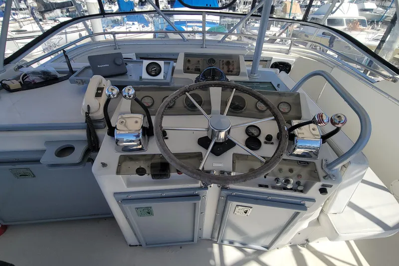 Slide: The Image of 1984 Uniflite 38 Convertible boat helm with steering wheel and control panel. - 14