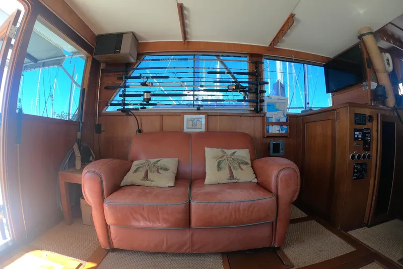 Slide: The Image of Interior of 1984 Uniflite 38 Convertible with leather sofa and nautical decor. - 18