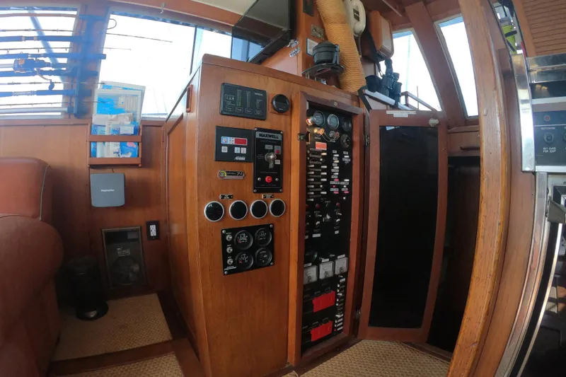 Slide: The Image of 1984 Uniflite 38 Convertible yacht interior with control panel and fishing rods. - 19