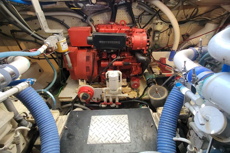 Slide: The Image of Engine room of 1984 Uniflite 38 Convertible with Westerbeke generator and various mechanical components. - 29