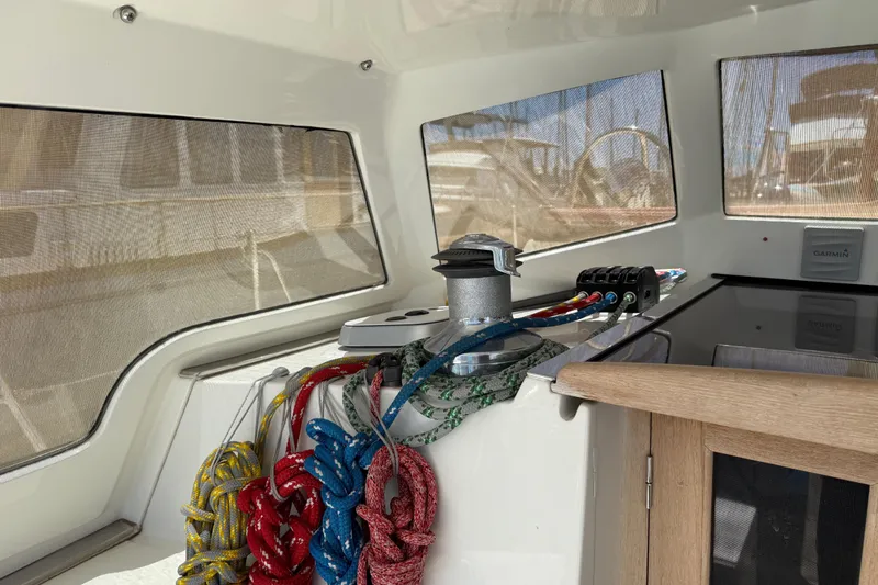 Slide: The Image of Cockpit of 2011 Outbound 46 sailboat with ropes and navigation equipment. - 13