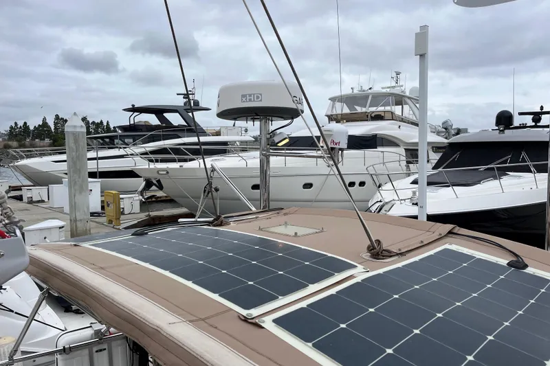 Slide: The Image of Boats docked at marina, featuring 2011 Outbound 46 with solar panels. - 23