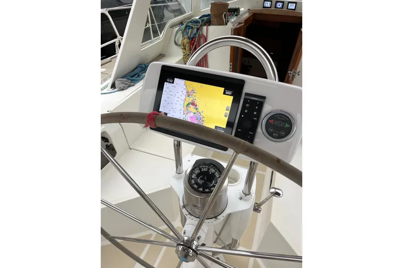 Slide: The Image of Steering wheel and navigation system on 2011 Outbound 46 sailboat cockpit. - 30
