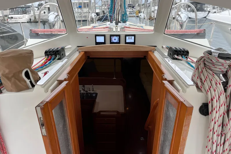 Slide: The Image of Cockpit view of 2011 Outbound 46 sailboat with navigation instruments and cabin entrance. - 32