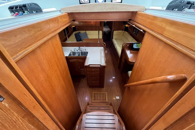 Slide: The Image of Interior view of 2011 Outbound 46 yacht, featuring wooden cabinetry and seating area. - 33