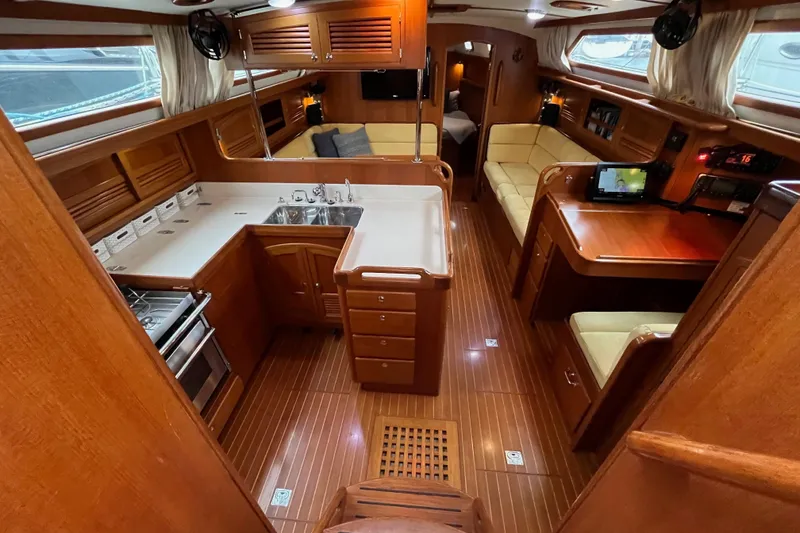 Slide: The Image of Luxurious interior of a 2011 Outbound 46 yacht featuring a spacious kitchen and seating area. - 34