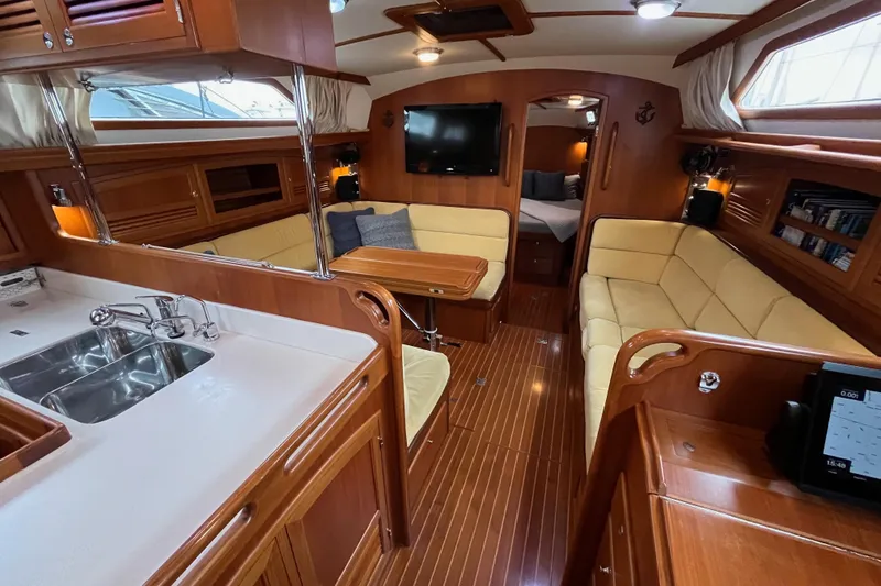 Slide: The Image of Luxurious 2011 Outbound 46 yacht interior with wood finish, cozy seating, and modern amenities. - 35
