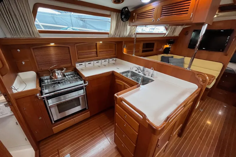 Slide: The Image of Luxurious 2011 Outbound 46 yacht interior with modern kitchen and cozy seating area. - 37