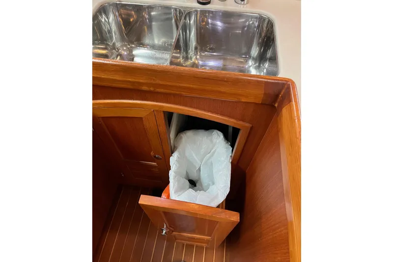 Slide: The Image of Wooden cabinet with trash bin and stainless steel sink on Outbound 46 yacht, 2011 model. - 41