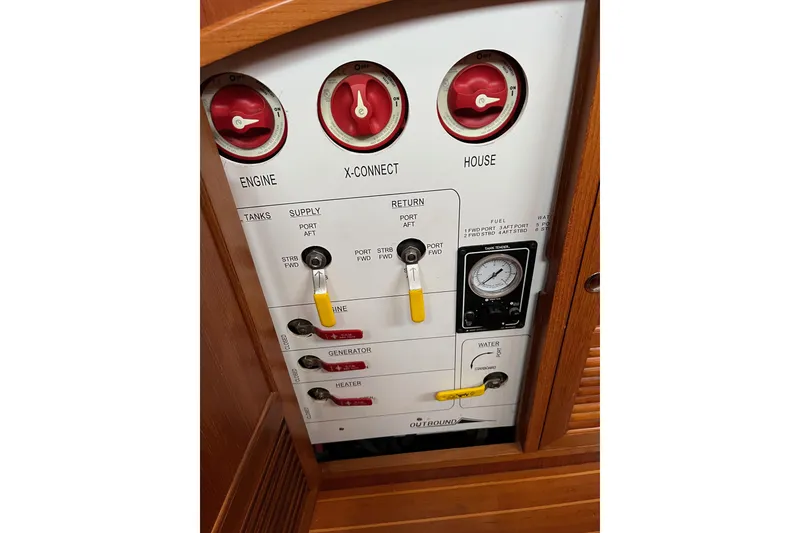 Slide: The Image of Control panel of a 2011 Outbound 46 yacht with tank valves and battery switches across from the nav station - 42