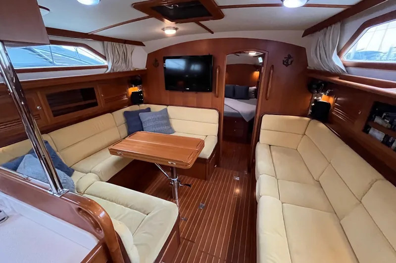 Slide: The Image of Luxurious interior of 2011 Outbound 46 yacht with cozy seating and elegant wood finish. - 44