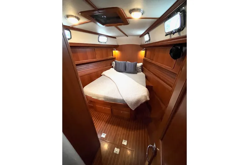 Slide: The Image of Luxurious cabin interior of 2011 Outbound 46 yacht with cozy bed and wooden finish. - 48