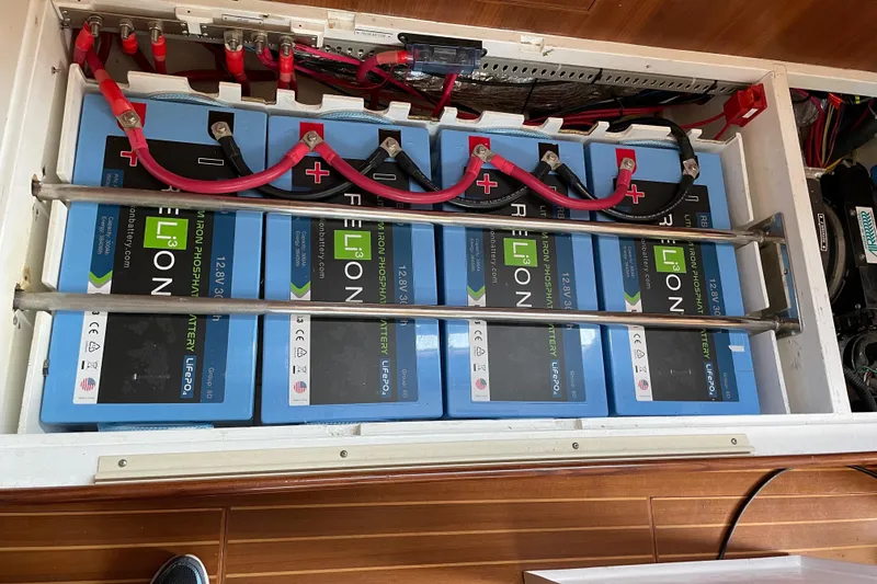 Slide: The Image of Lithium iron phosphate batteries in 2011 Outbound 46 yacht, neatly arranged with red cables. - 53