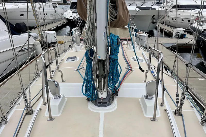 Slide: The Image of Sailboat deck view of 2011 Outbound 46 in marina, featuring granny bars and stainless steel cowls - 6