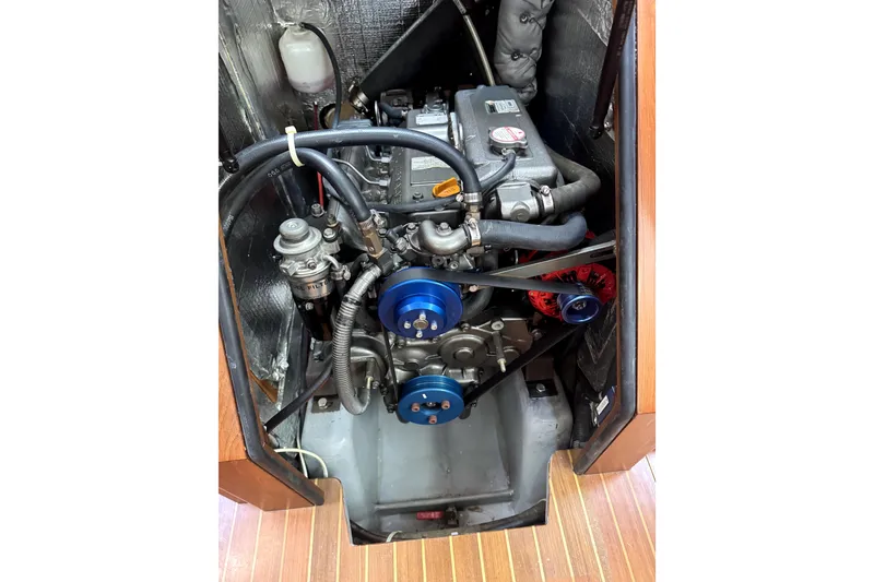 Slide: The Image of Engine compartment of a 2011 Outbound 46 sailboat, showcasing mechanical components. - 62