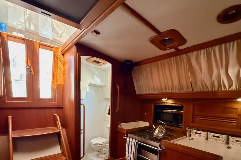 Slide: The Image of looking aft at the companionway and the head on starboard. - 63