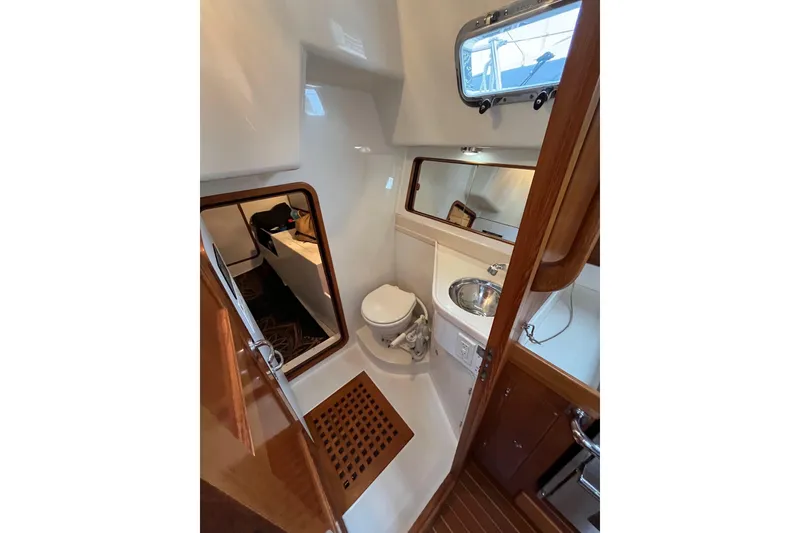 Slide: The Image of 2011 Outbound 46 yacht head with sink, toilet, access to aft storage - 65