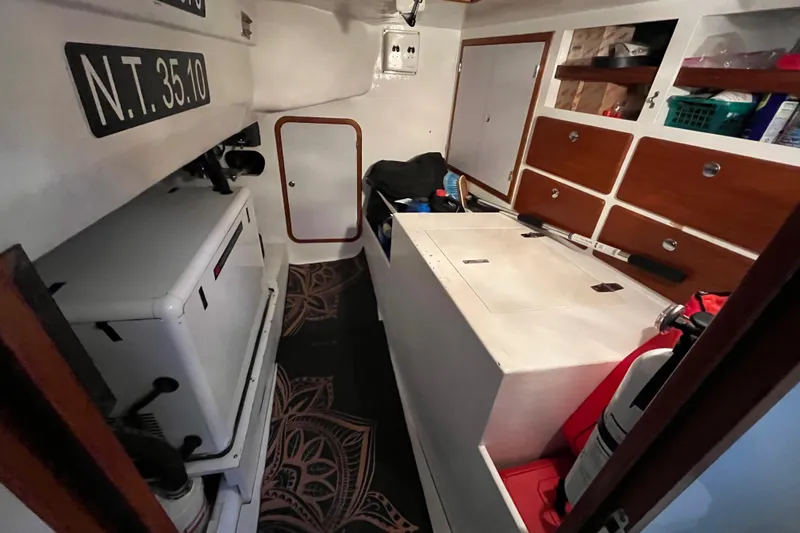 Slide: The Image of Interior of 2011 Outbound 46 showing generator and freezer in the sailboat storage area that opens up in the cockpit - 66