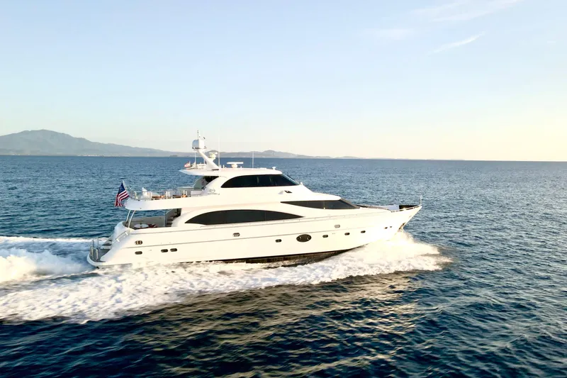 Slide: The Image of Luxurious 2011 Horizon E88 yacht cruising on open sea at sunset. - 1