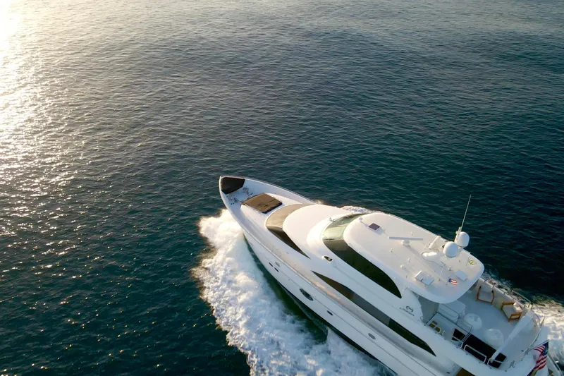 Slide: The Image of Luxury Horizon E88 yacht deck with elegant seating, wooden table, and ocean view, 2011 model. - 24