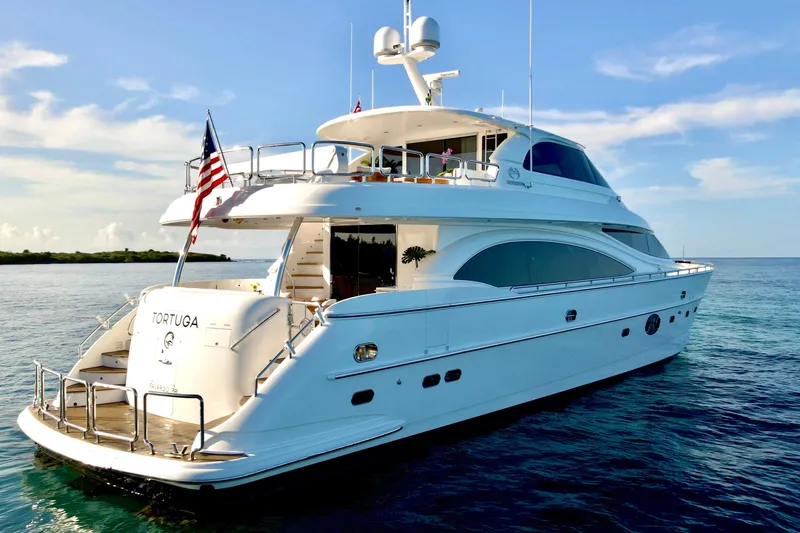 Slide: The Image of Luxurious bedroom interior on 2011 Horizon E88 yacht, featuring elegant wood finishes and plush bedding. - 33