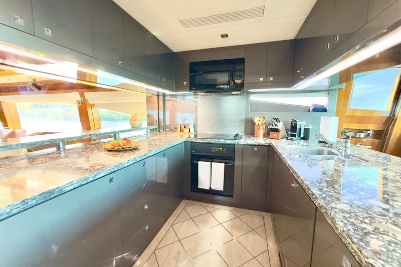 Slide: The Image of Luxurious kitchen interior on 2011 Horizon E88 yacht with modern appliances and granite countertops. - 65