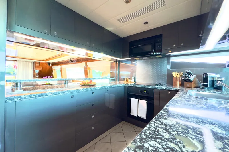 Slide: The Image of Luxurious kitchen interior on 2011 Horizon E88 yacht with modern appliances and sleek countertops. - 66