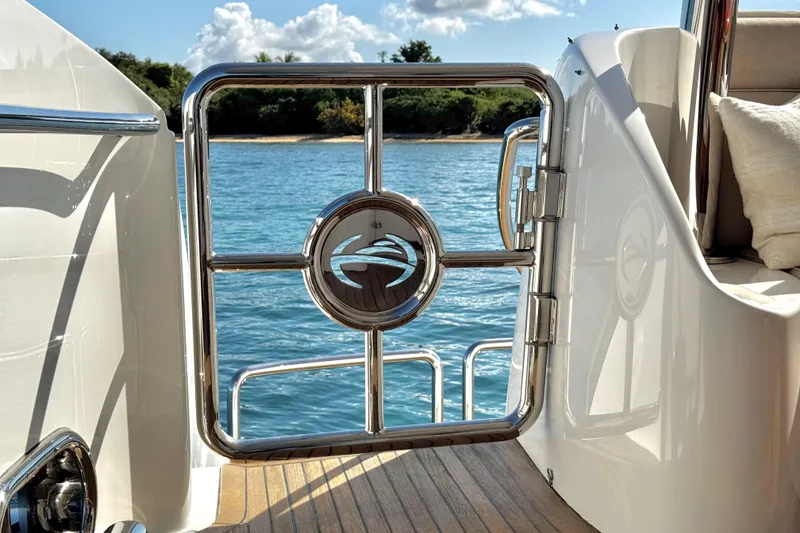 Slide: The Image of Stainless steel gate on Horizon E88 yacht, overlooking serene blue water. - 70