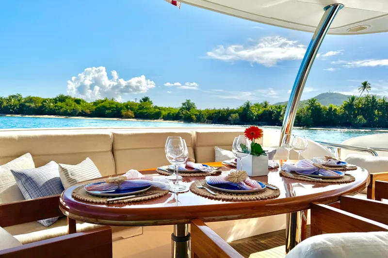 Slide: The Image of Luxurious Horizon E88 yacht dining area with elegant table setting, ocean view, and tropical backdrop. - 75