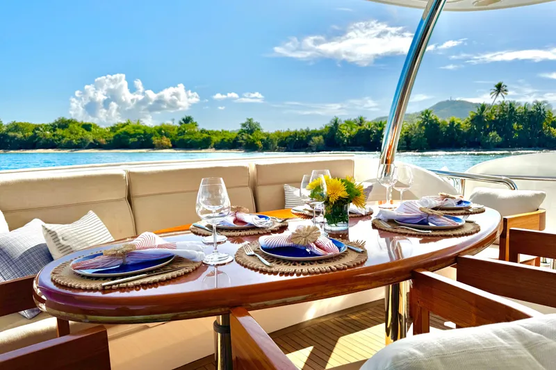 Slide: The Image of Luxurious dining setup on Horizon E88 yacht, 2011 model, with ocean view and elegant tableware. - 77