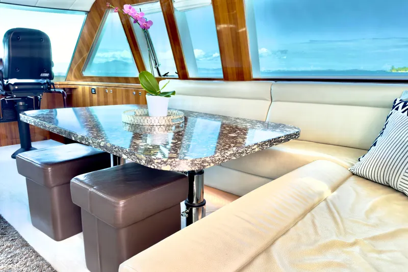 Slide: The Image of Luxurious Horizon E88 yacht interior with marble table, leather seating, and ocean view. - 83
