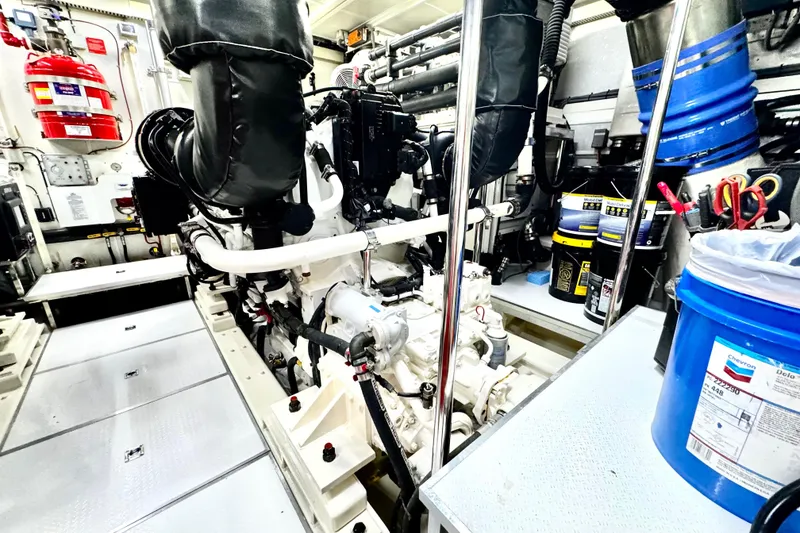 Slide: The Image of Engine room of 2011 Horizon E88 yacht, featuring machinery and maintenance supplies. - 90